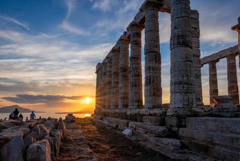 Cape Sounio sunset at Sounion with ruins of the iconic Poseidon temple. One of the Twelve Olympian Gods of ancient Greek religion and mythology. God of the sea