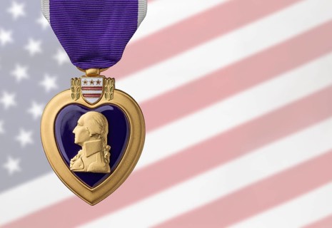 Purple heart miltary merit medal against ghosted american flag