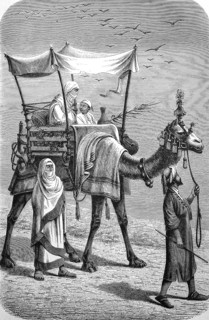 Women travelling on a camel through the desert