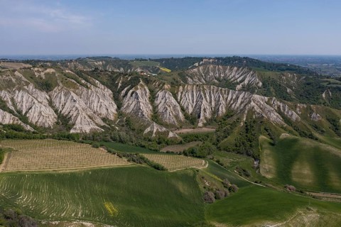 Aerial view of a hilly landscape with erosion valleys