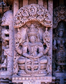 Close up of stone sculpture of dancing Lakshmi in Hoysala architecture at Somnathpur