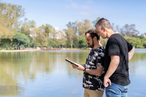 Couple of mature men reading in a lake