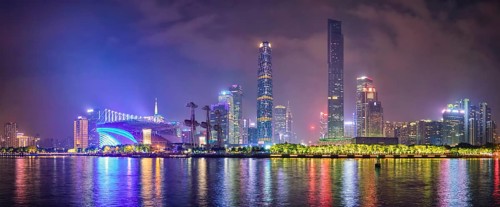 Guangzhou cityscape skyline over the Pearl River illuminated in the evening. Guangzhou