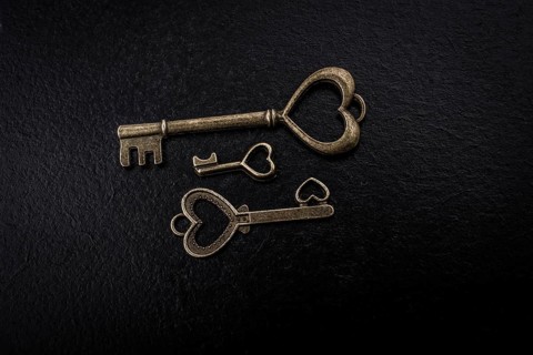 Heart shaped retro metal keys on dark background