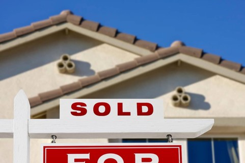 Sold home for sale real estate sign and house