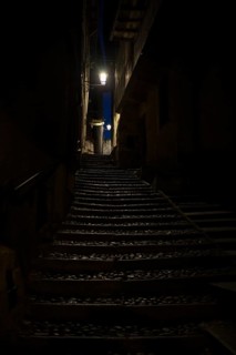 Narrow dark alley with stairs in Cannobio