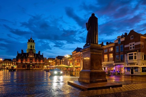 Delft City Hall and Delft Market Square Markt with Hugo de Groot Monument in the evening