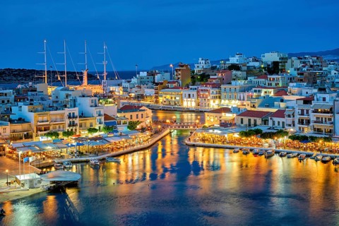 Beautiful Agios Nikolaos town on lake Voulismeni at night. Lasithi region of Crete island