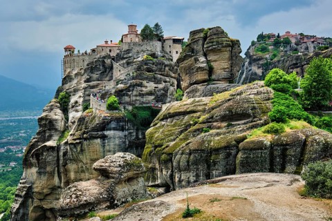Monastery of Varlaam monastery and Monastery of Great Meteoron in famous greek tourist destination Meteora in Greece on sunset with scenic scenery landscape
