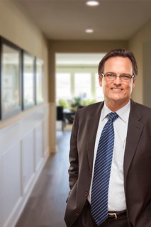 Smiling businessman in hallway of new house