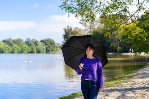Latin woman with umbrella on a sunny day