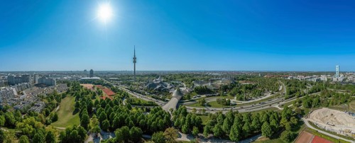 Panoramic view over Munich with the Olympic Tower in the Olympic Park under a blue sky in spring