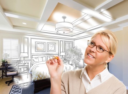 Creative woman with pencil over custom bedroom design drawing and photo combination