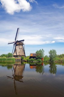Historic windmill reflected in a canal
