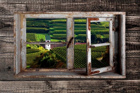 View through a rustic wooden window on Oberbergen