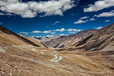 View of Karakoram range and road in valley from Kardung La