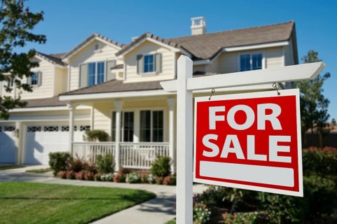 Home for sale sign in front of new house
