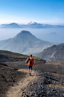 Hikers on hiking trail through volcanic landscape
