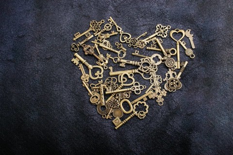 Retro metal keys form a heart shape on black