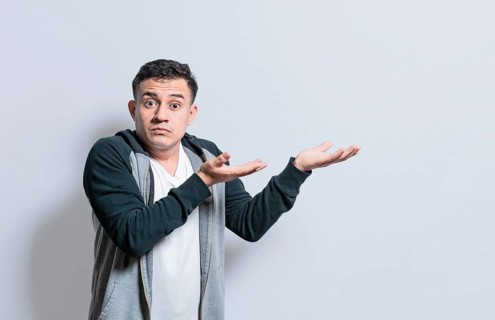 Person pointing palms to the side