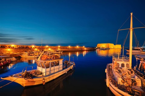 Venetian Fort Venetian fortress of Koules Castello a Mare castle in Heraklion and moored Greek fishing boats in port
