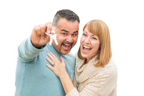 Happy mixed-race couple isolated on white holding new house keys