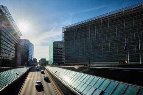Street traffic in Brussels near European Commission building on sunset