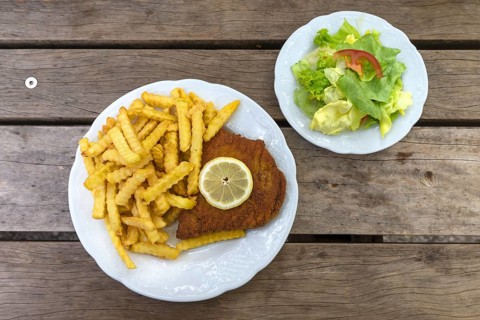 Cordon bleu with french fries and salad plate served in an inn