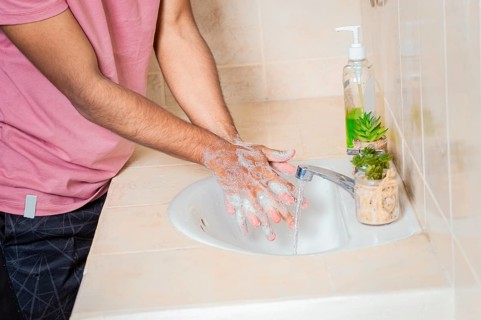 Close up of a man washing their hands with soap