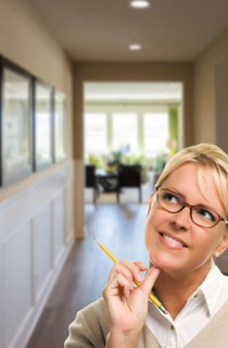 Woman with pencil inside the hallway of new house
