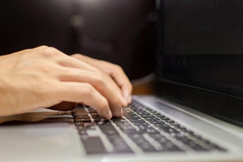 Hands on laptop keyboard