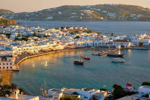 View of Mykonos town Greek tourist holiday vacation destination with famous windmills