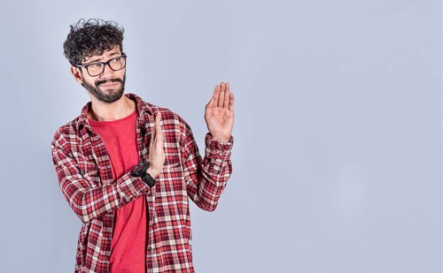 Disgusted intense man with rejection gesture