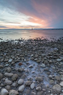 Sunrise on a wintry lake in bad weather
