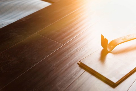 Pry bar tool with new laminate flooring abstract