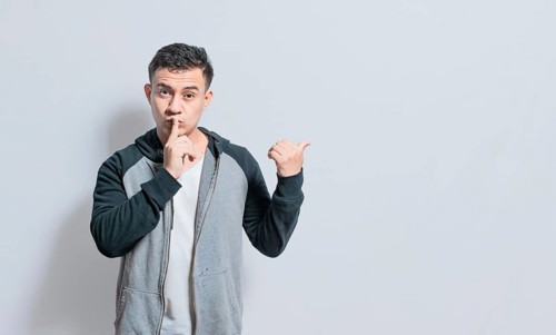 Person pointing to the side giving an offer isolated