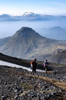 Two hikers on hiking trail through volcanic landscape