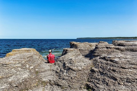 Hiker sitting between limestone columns
