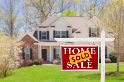 Sold home for sale real estate sign and beautiful new house
