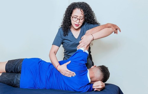 Female doctor with patient undergoing back treatment