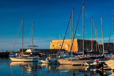 Venetian Fort Venetian fortress of Koules Castello a Mare castle in Heraklion and moored Greek fishing boats in port