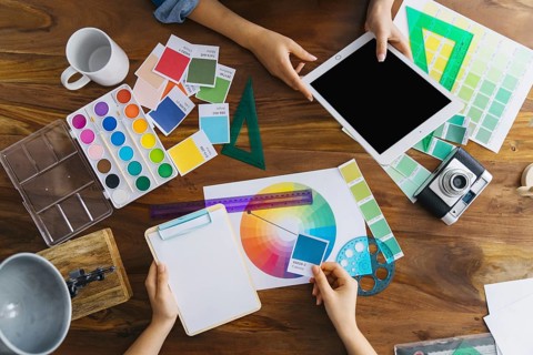 Artists working desk with colors and tools