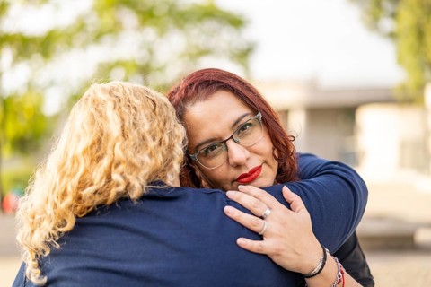 Couple of lesbian women hugging in a park
