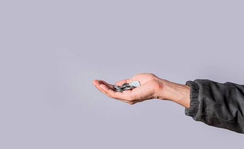 Hands with several coins in isolated background