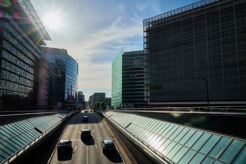Street traffic in Brussels near European Commission building on sunset