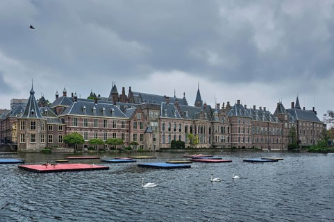 View of the Binnenhof House of Parliament and the Hofvijver lake with swans