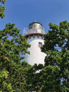 White lighthouse Langer Erik between trees