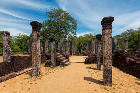 Standing Buddha statue in ancient ruins