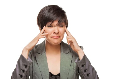 Grimacing biracial girl holding her head with her hands isolated against white background