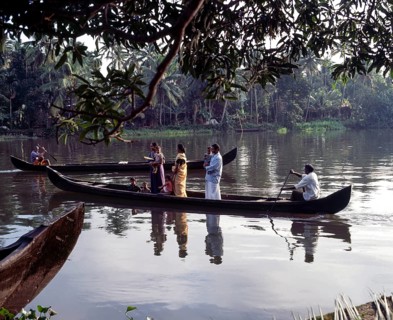 People being taken in a boat across the back waters of Alappuzha or Alleppey in Kerala